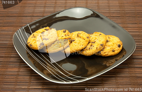 Image of plate of cookies on dark brown background