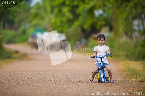 Image of cute girl riding her bike