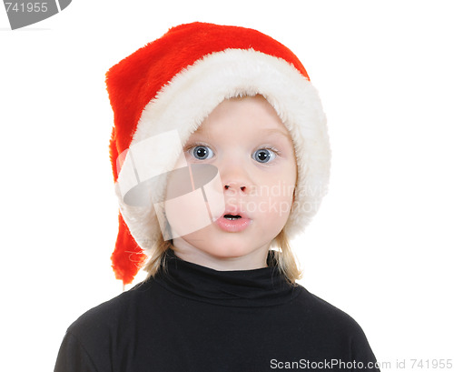 Image of The child in a hat santa claus