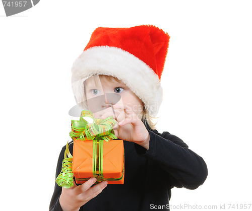 Image of The child in a hat santa claus