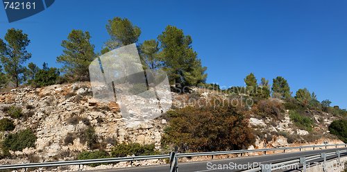 Image of Rocky hill above the highway landscape