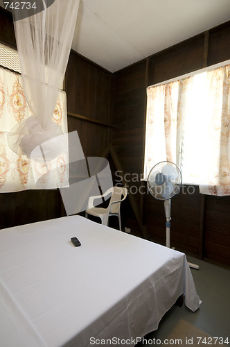 Image of budget guest house room with mosquito net