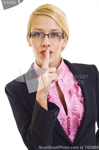 Image of businesswoman with her finger on her lips