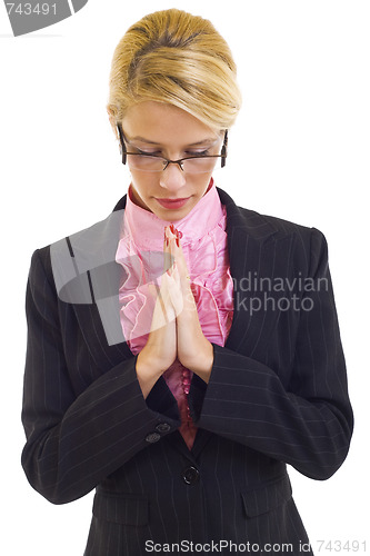 Image of young business woman praying