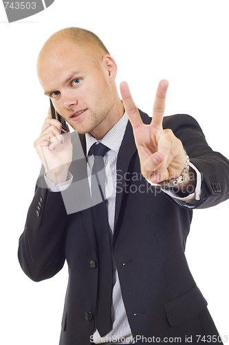 Image of businessman on the phone making his victory sign