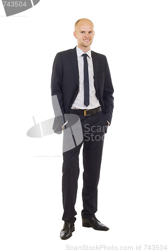 Image of man in black suit with hands in pockets