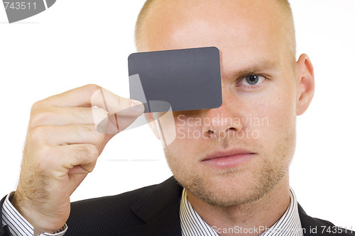 Image of Young businessman with blank card in his hand