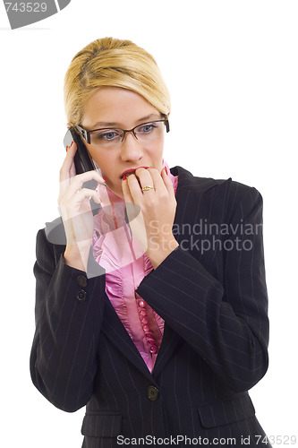 Image of Worried businesswoman speaking by phone