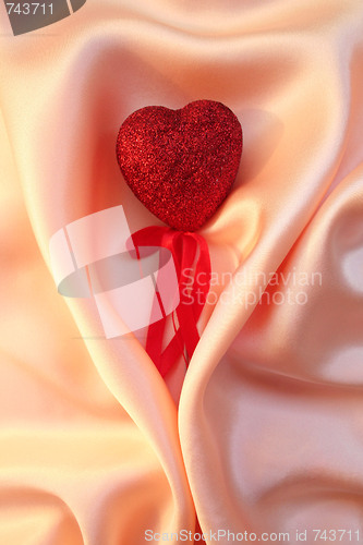 Image of Red heart on elegant pink silk for St Valentine's day background