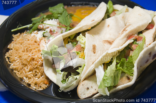 Image of combination steak fajita and chicken fajita with refried beans a