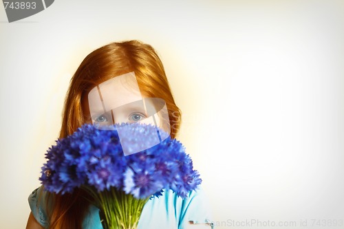 Image of Portrait of redhead girl with cornflowers