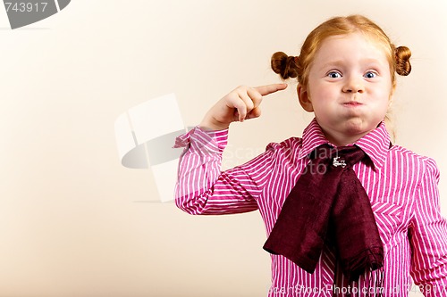 Image of Portrait of cute elegant redhead girl blowing cheeks