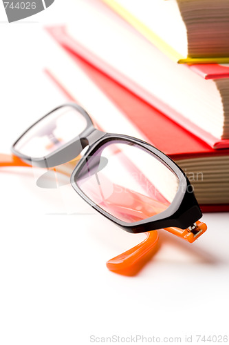 Image of stack of books and glasses