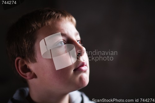 Image of Young boy looking up with hope in his eyes copy space