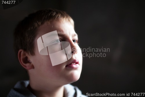 Image of Young boy looking up with hope in his eyes shallow DOF