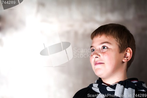 Image of Young boy looking up with hope in his eyes copy space Strong main light