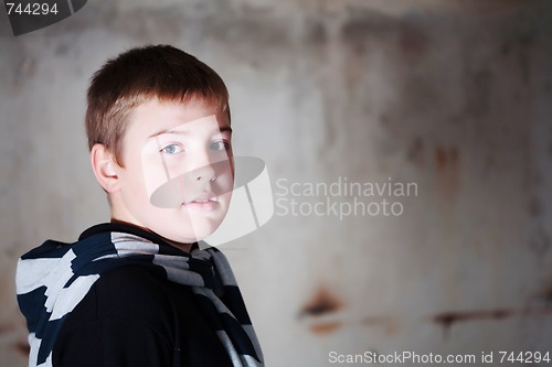 Image of Boy looking over the shoulder against grunge background lit with 3 flashes