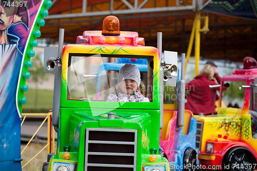 Image of Little girl in amusement park