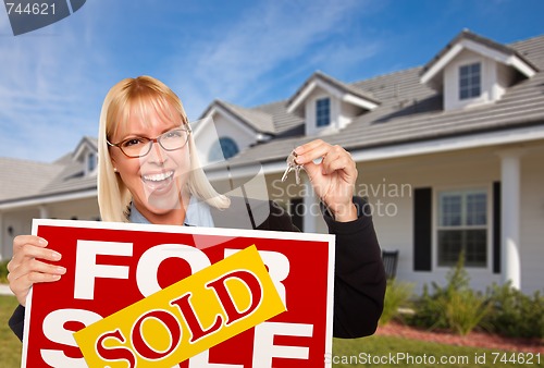 Image of Beautiful Female Holding Keys & Sold Real Estate Sign