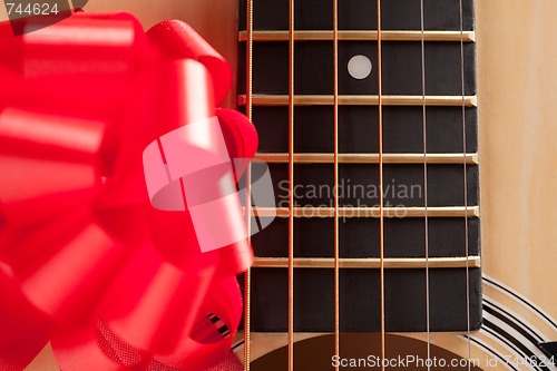 Image of Guitar Strings with Red Ribbon