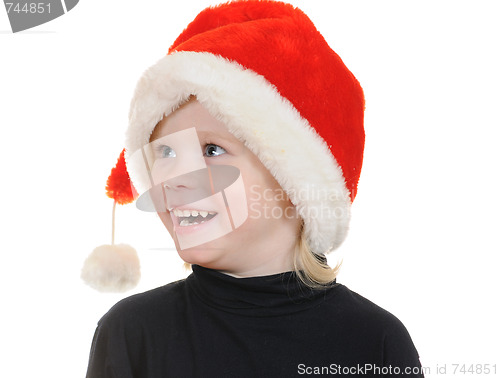 Image of The child in a hat santa claus
