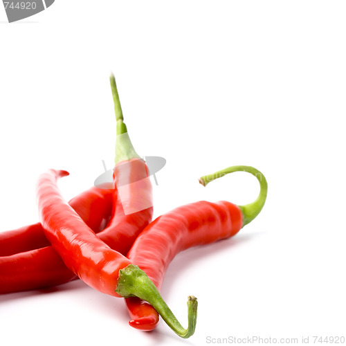 Image of four red chilly peppers