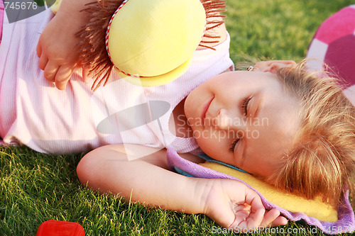 Image of Happy girl relaxing on a grass