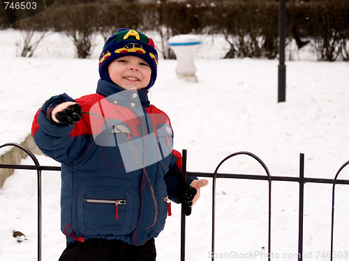 Image of The little boy in the street in the winter