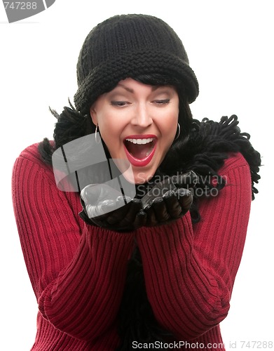 Image of Excited Woman In Winter Clothes Holds Her Hands Out