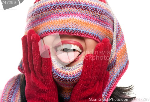 Image of Attractive Woman With Colorful Scarf Over Eyes Sticking Out Tong