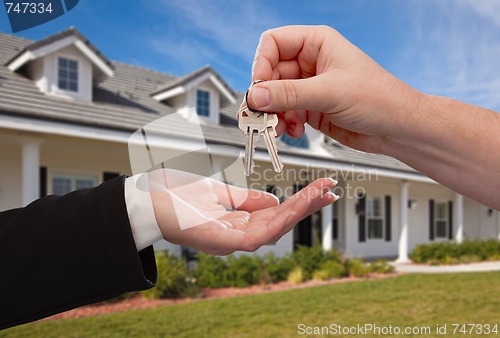 Image of Handing Over the House Keys in Front of New Home