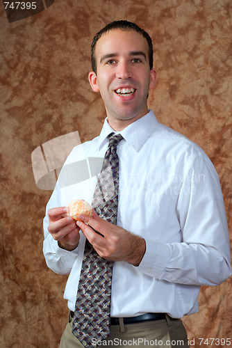 Image of Businessman Having Orange For Snack