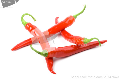 Image of four red chilly peppers