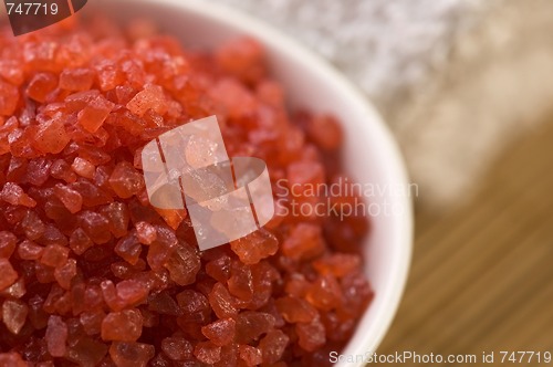 Image of bath salt and towel. red and white.