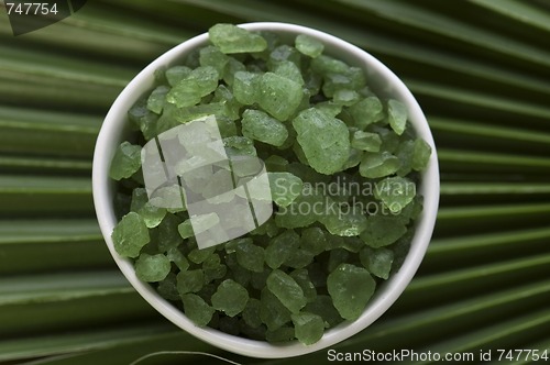 Image of bath salt and palm leaf