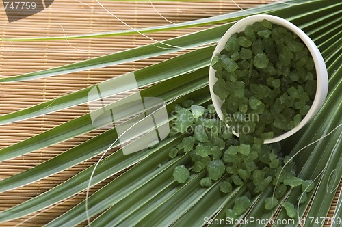 Image of bath salt and palm leaf