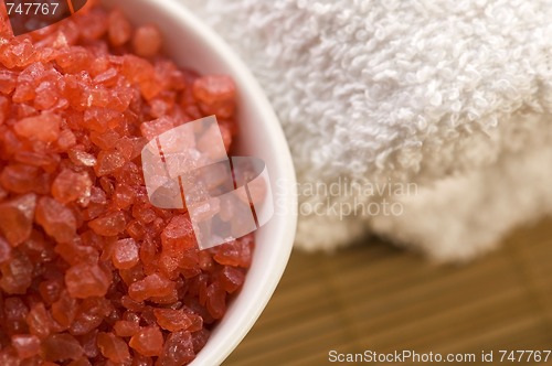 Image of bath salt and towel. red and white.