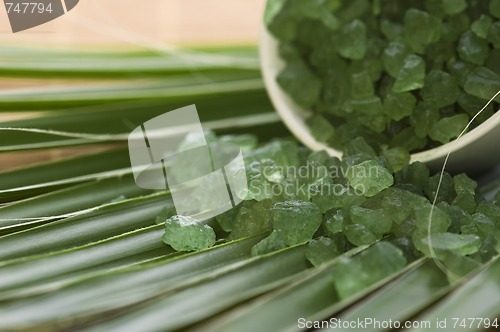 Image of bath salt and palm leaf