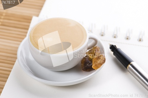 Image of pen, notebook and cup of coffee