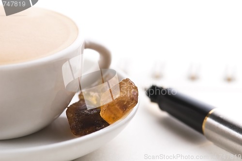 Image of pen, notebook and cup of coffee