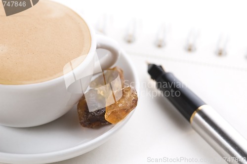 Image of pen, notebook and cup of coffee