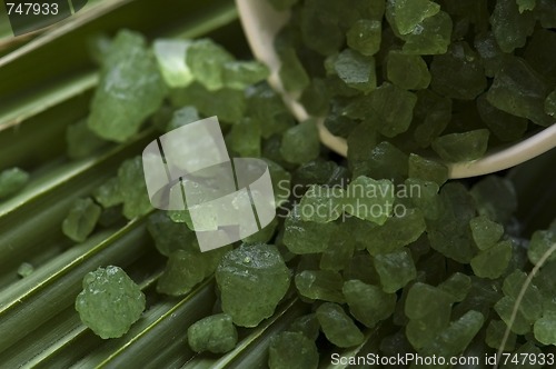 Image of bath salt and palm leaf