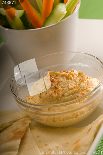 Image of hummus dip with pita bread and vegetable