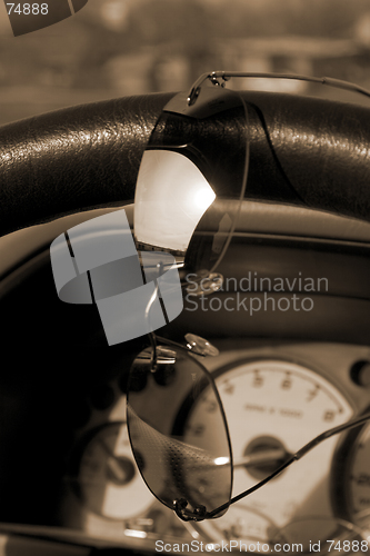 Image of Sunglasses on the steering wheel