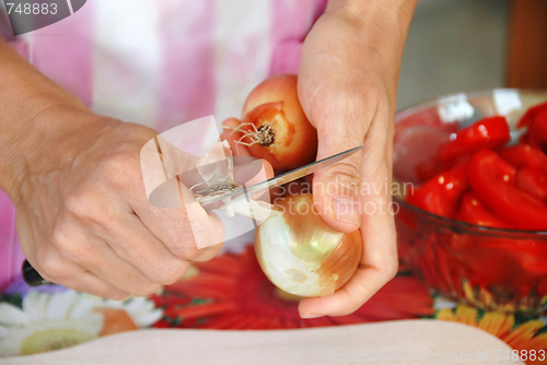 Image of Woman pilling onion