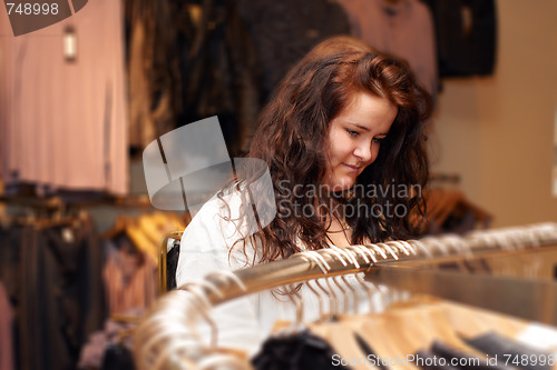 Image of Shopping - Young woman looking at clothes 