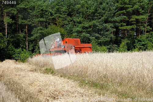 Image of harvester harvesting a grain field