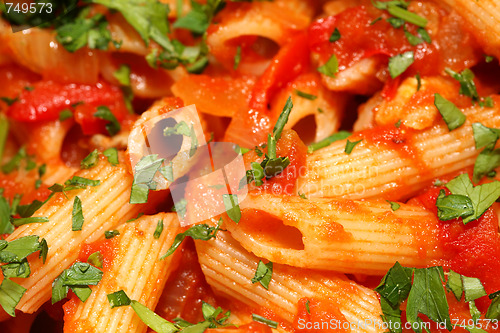 Image of Penne rigate pasta with tomato sauce. background