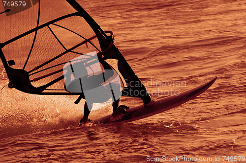 Image of Surfer on the waves in  sunset