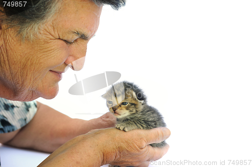 Image of Senior woman holding kitten